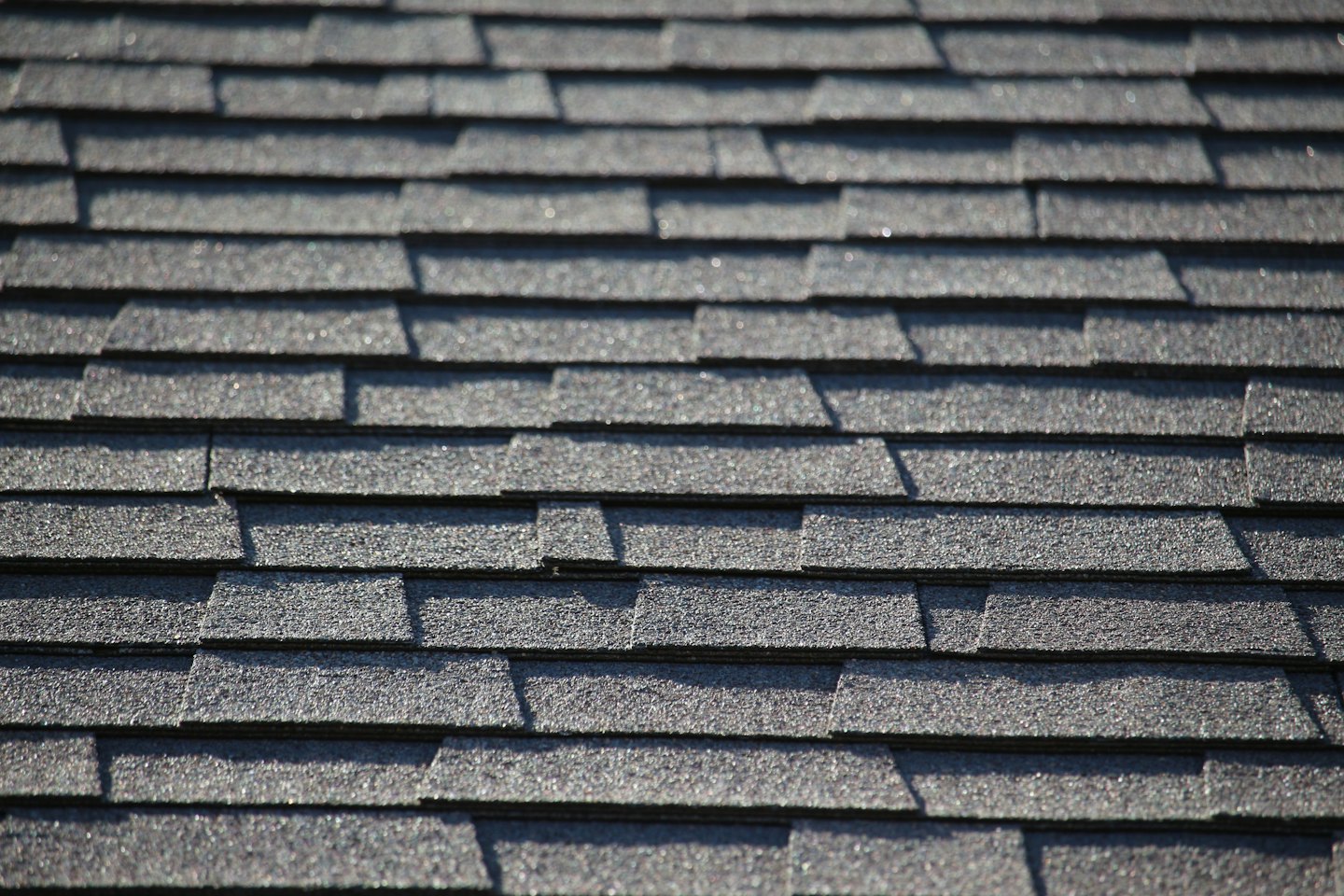 Dark grey asphalt shingles on a roof.